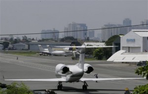 A Gulf Stream private jet chartered by Grammy award-winning singer Chris Brown, sits at the end of a taxiway housing private hangars of the Manila Domestic Airport at suburban Pasay city, south of Manila, Philippines Thursday, July 23, 2015. Chris Brown, who performed at a packed concert Tuesday night, was barred from leaving the country following fraud allegations against him and his promoter for a canceled concert last New Year's Eve in the Philippines. (AP Photo/Bullit Marquez)