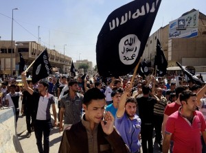 FILE - In this Monday, June 16, 2014 file photo, demonstrators chant pro-Islamic State group slogans as they wave the group's flags in front of the provincial government headquarters in Mosul, 225 miles (360 kilometers) northwest of Baghdad, Iraq. Islamic State militants have abducted at least 70 Assyrian Christians, including women and children, after overrunning a string of villages in northeastern Syria, two activist groups said Tuesday, Feb. 24, 2015. (AP Photo, File)