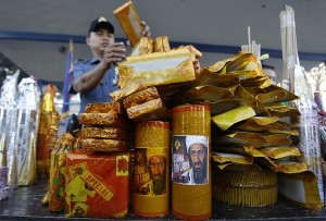 A firecracker named "Bin Laden" is arranged by a Filipino policeman as he piles seized illegal firecrackers at Camp Karingal in suburban Quezon city, north of Manila, Philippines on Saturday Dec. 29, 2012. The items were seized from vendors as part of their drive to suppress the use of illegal pyrotechnics or giant firecrackers during the New Year revelry which has caused injury or death to many Filipinos. (AP Photo/Aaron Favila)