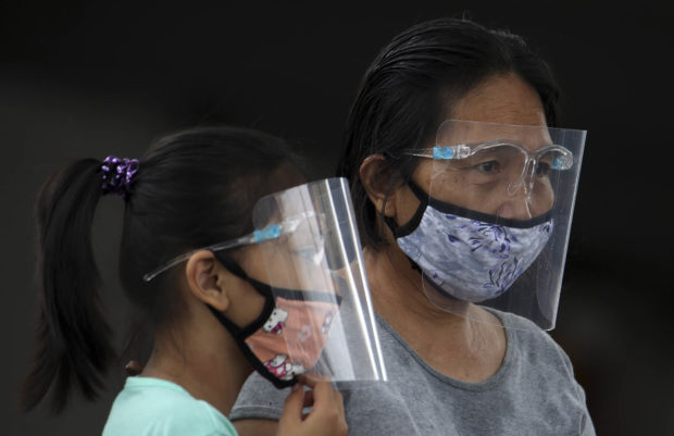 People wearing face mask and face shield.