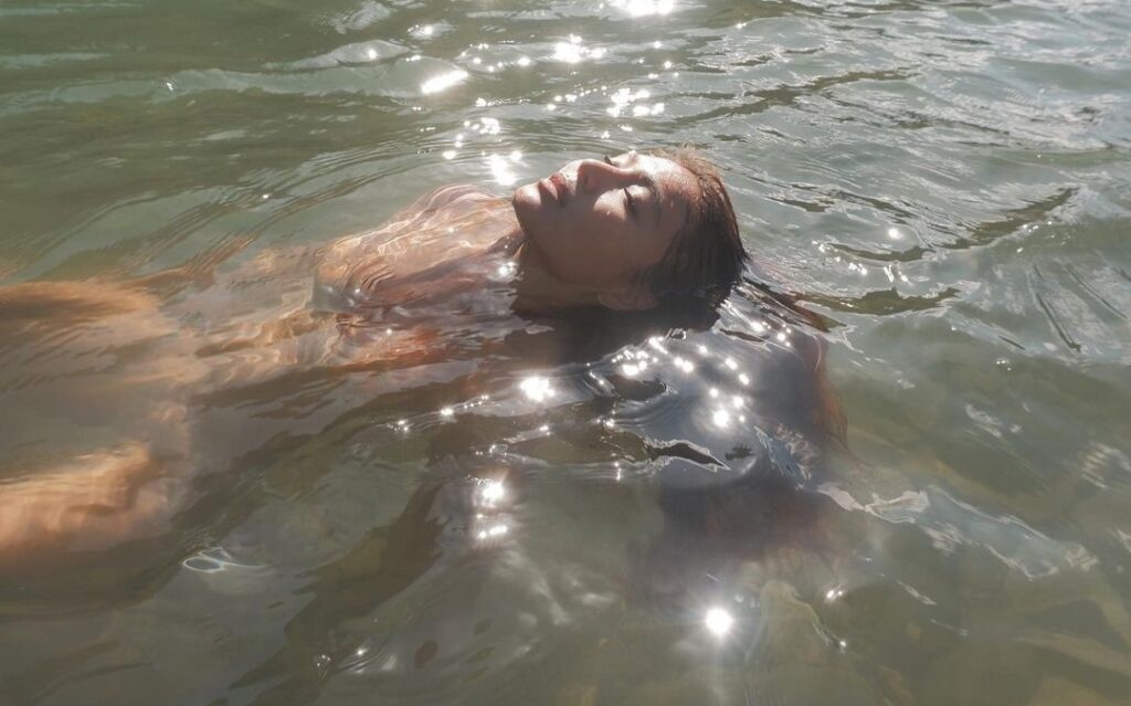 Nadine Lustre relaxes as she swims on the beach.